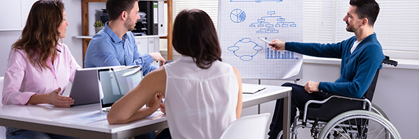Disables Young Businessman Giving Presentation To His Colleague