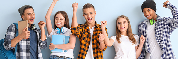 Portrait of happy young students on color background